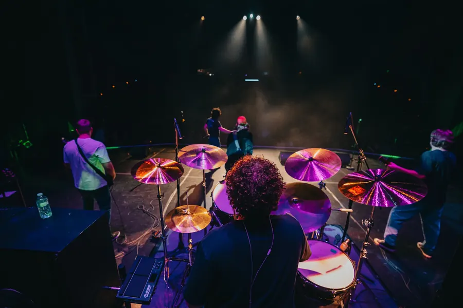 Looking over Andrew's shoulder from behind his drum kit